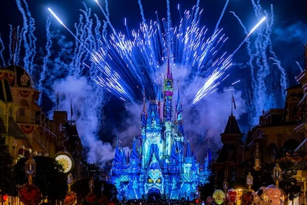 fireworks exploding in the sky above a castle