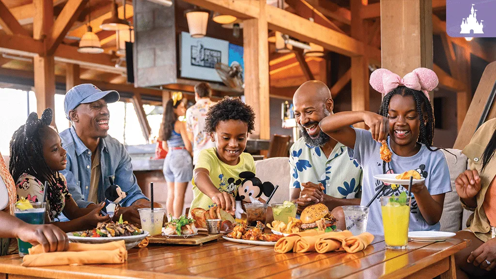 a group of people sitting at a table with food