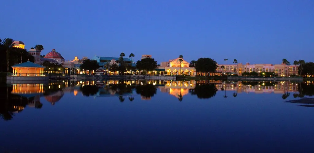 Disney's Coronado Springs Resort reflected on Lago Dorado at dusk