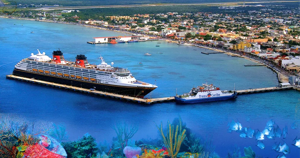 A Disney Cruise Line ship docked at Castaway Cay in turquoise water