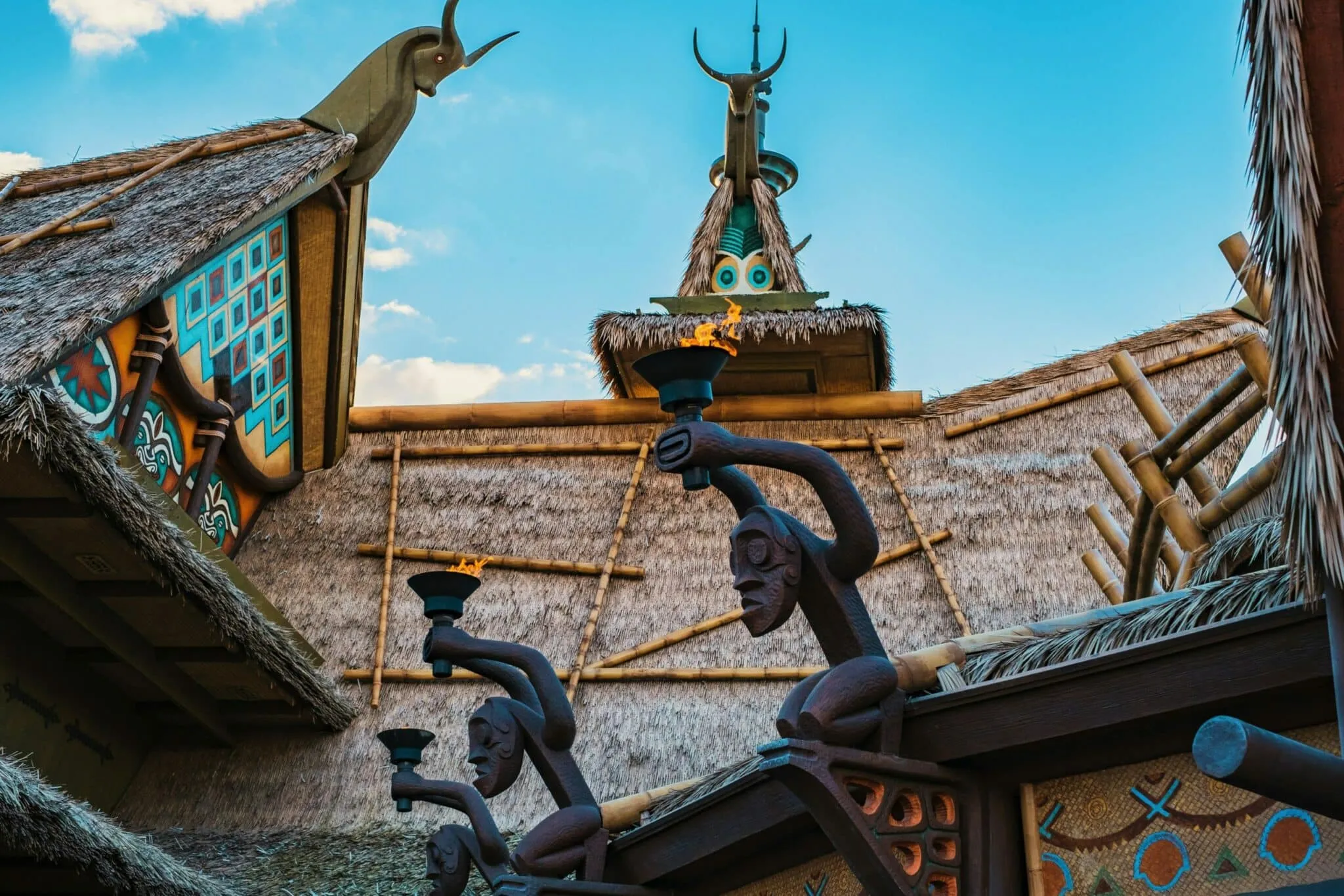 a building with a thatched roof and statues