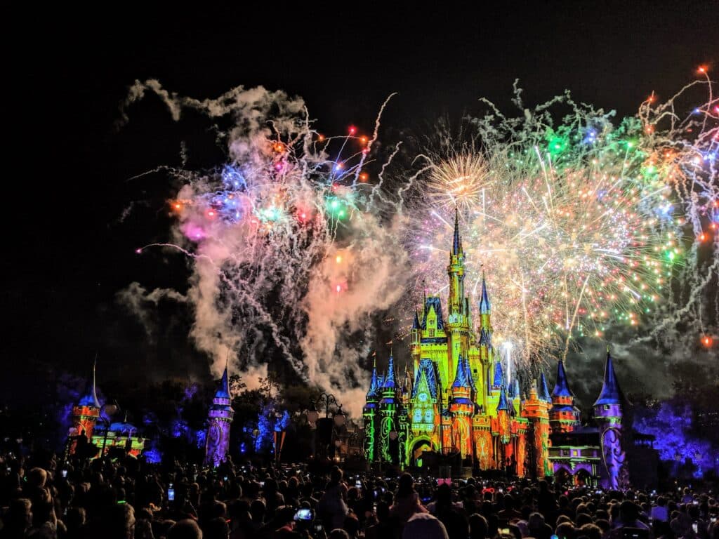 Disney castle with fireworks at night