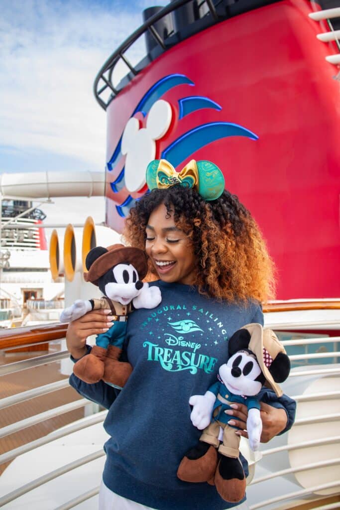 a woman holding two stuffed toys